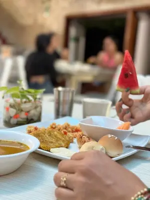 a person holding a slice of watermelon on a plate of food at Hotel Toledo FL in Cartagena de Indias