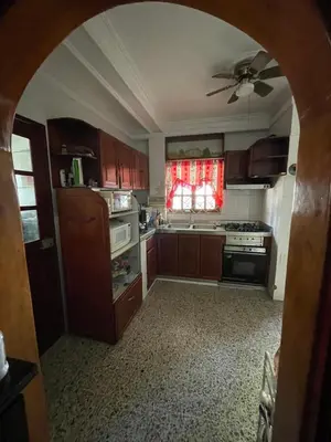 a kitchen with wooden cabinets and a ceiling fan at MAR uno in Cartagena de Indias