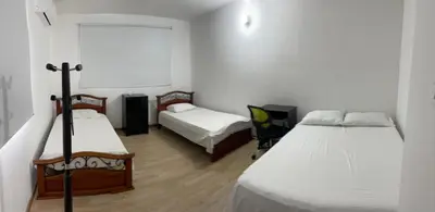 a small room with two beds and a window at MAR uno in Cartagena de Indias