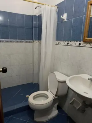 a bathroom with a toilet and a sink at Hotel El Puerto in Tolú