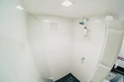 a bathroom with a shower and a white wall at Apartamento Lorenita in Cartagena de Indias