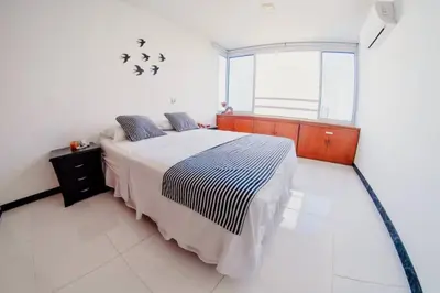 a bedroom with a bed and a large window at Apartamento Lorenita in Cartagena de Indias
