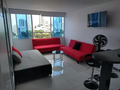 a living room with a red couch and a table at Apartamento Lorenita in Cartagena de Indias