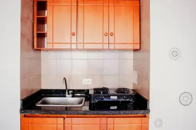 a kitchen with wooden cabinets and a sink at Apartamento Lorenita in Cartagena de Indias