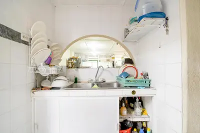 a kitchen with a sink and a counter with dishes at HABITACION PRIVADA EN CASA DE MIS PADRES in Barranquilla