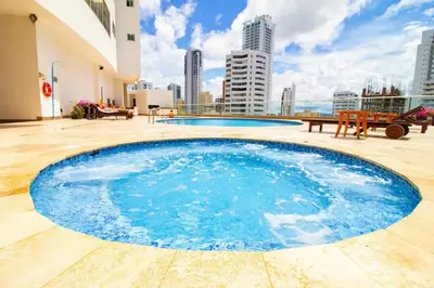 a large blue swimming pool on top of a building at Apartamento Palmetto Eliptic - Best Seaview in Cartagena de Indias