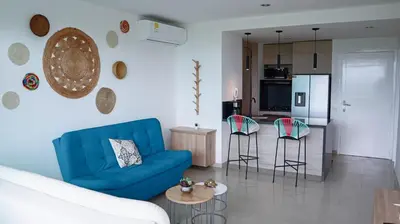 a living room with a blue couch and chairs at MORROS EPIC 1 ALCOBA VISTA CIENAGA in Cartagena de Indias