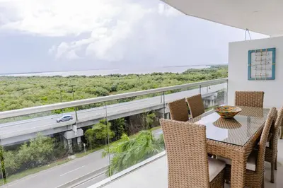 a dining room with a table and chairs on a balcony at MORROS EPIC 1 ALCOBA VISTA CIENAGA in Cartagena de Indias