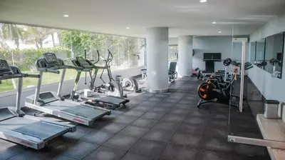 a gym with several tread machines and a large window at MORROS EPIC 1 ALCOBA VISTA CIENAGA in Cartagena de Indias