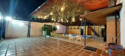 a room with a table and chairs and lights at CABAÑA LAS MARIAS, Climatizada, Piscina y BBQ in Santa Marta
