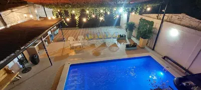 an overhead view of a swimming pool at night at CABAÑA LAS MARIAS, Climatizada, Piscina y BBQ in Santa Marta