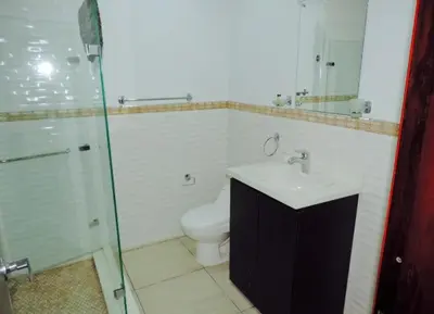 a bathroom with a toilet and a sink and a shower at Cristoforo Oasis in Cartagena de Indias
