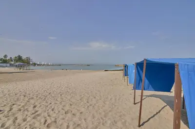 a row of blue nets on a sandy beach at Hermoso Apartamento Frente al Mar 2 Habitaciones PAZ122 in Coveñitas