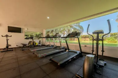 a row of exercise bikes in a gym with a window at Morros Epic 2 Bedrooms Beachfront by Inmobiliaria MFR in Cartagena de Indias
