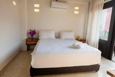 a bedroom with a large white bed with towels on it at Casa Familiar - Maria de las Palmas -Getsemani in Cartagena de Indias