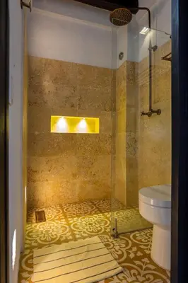 a bathroom with a shower and a toilet at Casa Familiar - Maria de las Palmas -Getsemani in Cartagena de Indias
