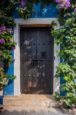 a blue and white house with a black door at Casa Familiar - Maria de las Palmas -Getsemani in Cartagena de Indias