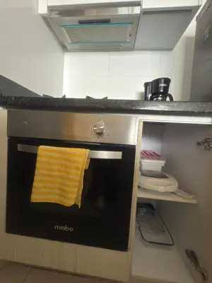 a yellow towel is on the door of an oven at Condo con vista al mar in Cartagena de Indias