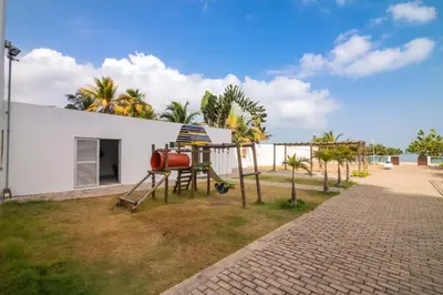 a playground in front of a white building at Magico Apartamento Frente al Mar 3 Habitaciones AR33 in Coveñas