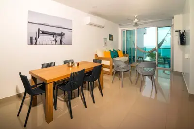 a dining room and living room with a table and chairs at Magico Apartamento Frente al Mar 3 Habitaciones AR33 in Coveñas