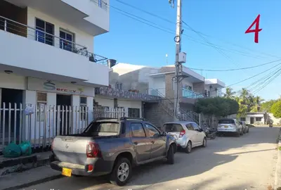 a row of cars parked in front of a building at Apartamento JHON in Coveñas