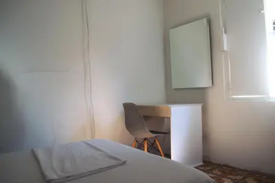a bedroom with a bed and a desk and a chair at Mango Tree Hostel CTG 420 in Cartagena de Indias