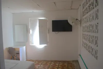 a room with a bed and a window and a desk at Mango Tree Hostel CTG 420 in Cartagena de Indias