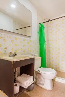 a bathroom with a toilet and a sink and a mirror at Mango Tree Hostel CTG 420 in Cartagena de Indias