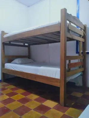 two bunk beds in a room with a checkered floor at Mango Tree Hostel CTG 420 in Cartagena de Indias