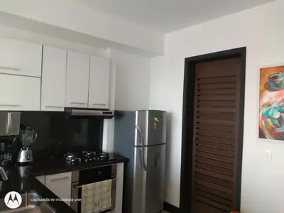 a kitchen with white cabinets and a stainless steel refrigerator at Caminando hacia la playa in Cartagena de Indias