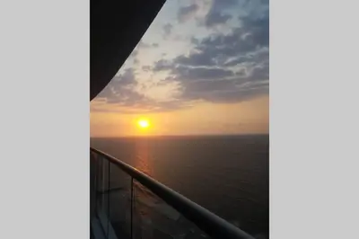a sunset from the balcony of a cruise ship at Caminando hacia la playa in Cartagena de Indias