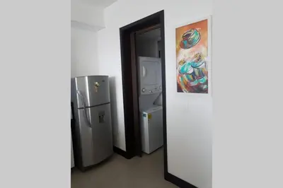 a room with two refrigerators and a painting on the wall at Caminando hacia la playa in Cartagena de Indias