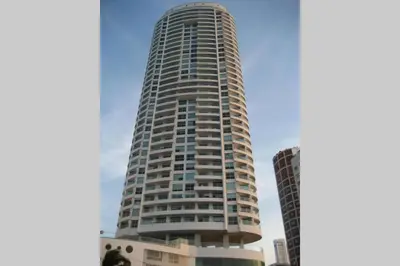 a tall building with a blue sky in the background at Caminando hacia la playa in Cartagena de Indias