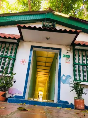 a house with a painting on the side of it at Tita’s Airport Hotel in Cartagena de Indias