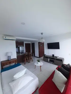 a living room with a large bed and a couch at Edificio frente al mar con playas tranquilas in Cartagena de Indias