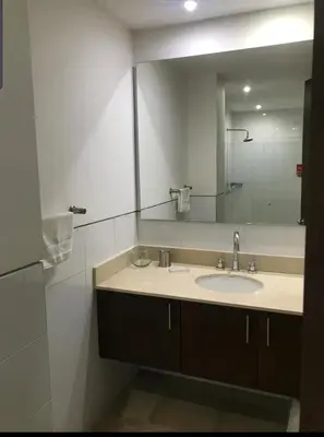 a bathroom with a sink and a large mirror at Vista directa al mar con amplia terraza y 3 habitaciones in Cartagena de Indias