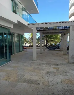 a patio outside of a building with a hammock at Vista directa al mar con amplia terraza y 3 habitaciones in Cartagena de Indias