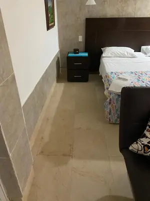 a bedroom with two beds and a tiled floor at Apartaestudio amplio in Barranquilla