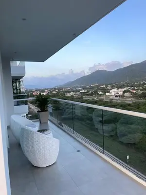 a balcony with two white chairs and a view at Loft de Lujo - Wifi, piscina y mar in Santa Marta