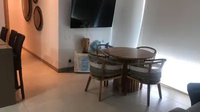a dining room with a wooden table and chairs at Loft de Lujo - Wifi, piscina y mar in Santa Marta