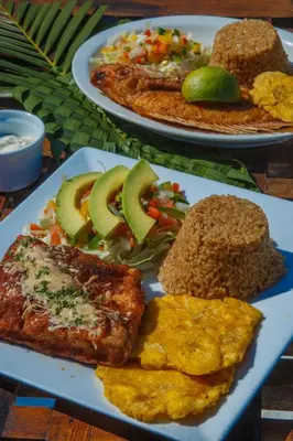 three plates of food on a table with food at Hotel Isla Del Pirata in Isla del Pirata