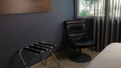 a black chair in a room with a window at The Blue Hotel in Cartagena de Indias