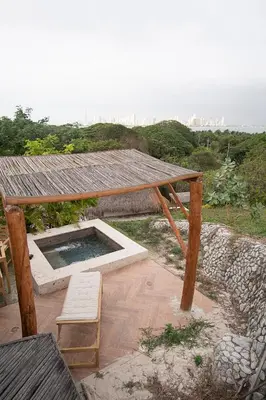 a pavilion with a table and a bench under it at AMALIFE Beach Club & Hotel in Tierra Bomba