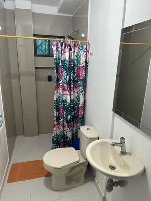 a bathroom with a toilet and a sink at San José Beach in Lomarena