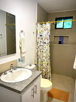 a bathroom with a sink and a shower curtain at San José Beach in Lomarena
