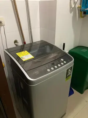 a stove top oven sitting next to a green trash can at Atlantis Suites -Amoblados Nuevos sector Buenavista in Barranquilla