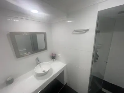 a white bathroom with a sink and a shower at Cómodo Apartamento en Bocagrande Cartagena 1503 in Cartagena de Indias