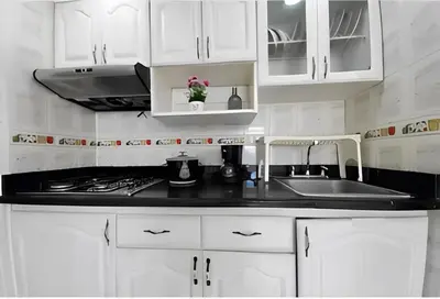 a white kitchen with white cabinets and a sink at Cómodo Apartamento en Bocagrande Cartagena 1503 in Cartagena de Indias
