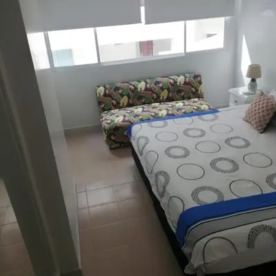 a small room with a bed and a couch at Cómodo Apartamento en Bocagrande Cartagena 1503 in Cartagena de Indias