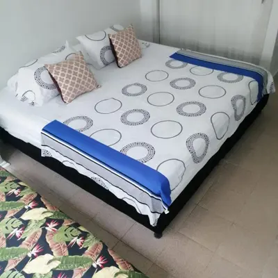 a bed with pillows on it in a room at Cómodo Apartamento en Bocagrande Cartagena 1503 in Cartagena de Indias